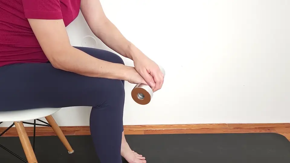 Eccentric wrist extension for tennis elbow, slowly lowering a light dumbbell with the forearm supported
