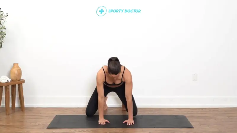 Person on hands and knees with knees wide apart and feet turned outward, lowering hips back to stretch the inner thighs and groin