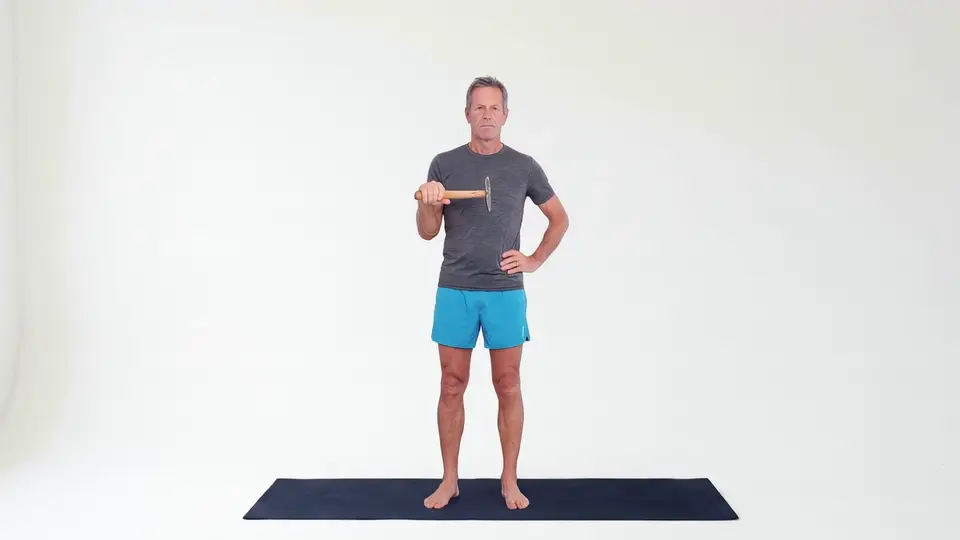 Hammer rotation exercise for tennis elbow, slowly turning a hammer from thumb-up to palm-down with the elbow at the side