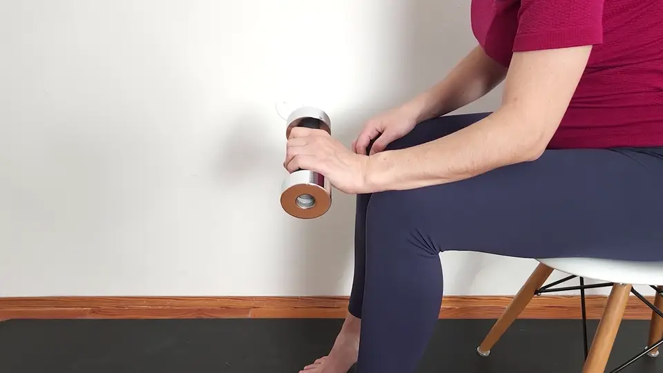 Isometric wrist extension hold for tennis elbow, forearm supported and wrist held still against a light dumbbell