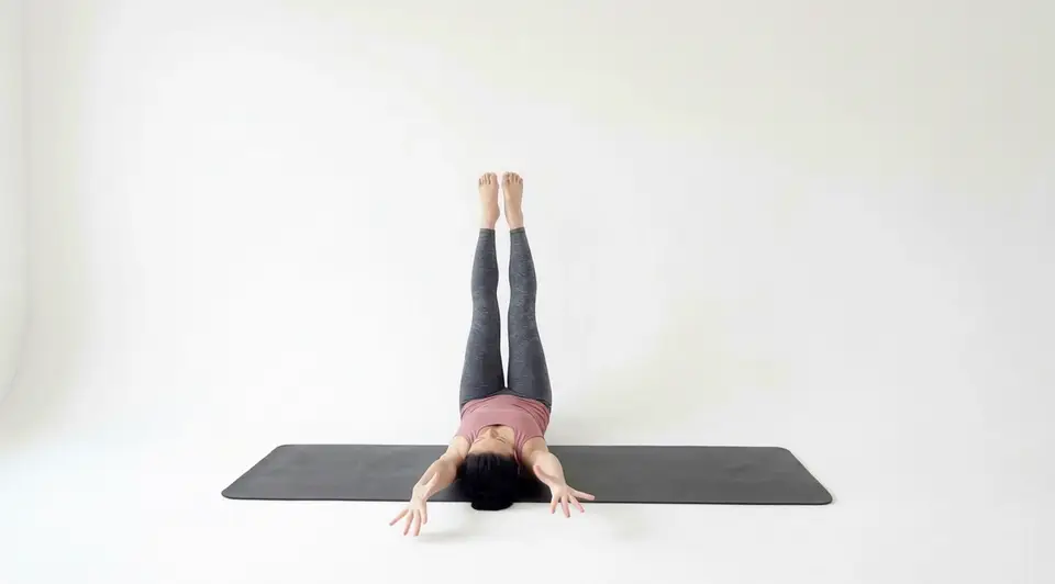 L5-S1 ELDOA decompression stretch held with the spine long and arms reaching overhead