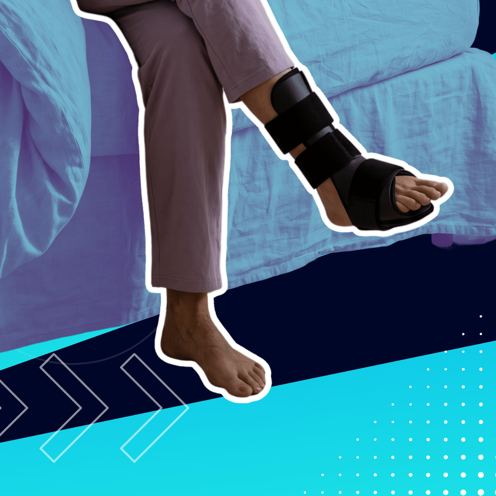 Person sits with one leg in a black medical boot resting on a blue bed, the other leg bare.