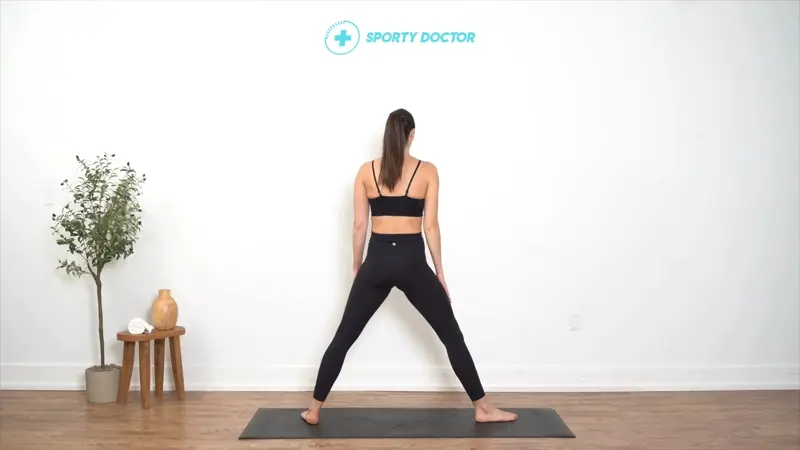 Person performing Triangle Pose with one hand on shin and the other extended overhead, improving balance and flexibility.