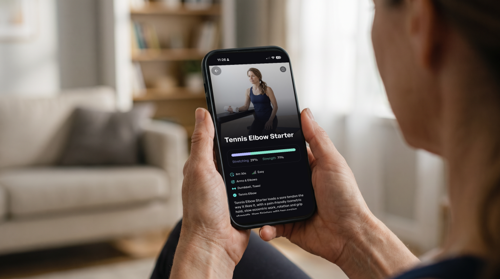 Woman holding a phone and looking at the Tennis Elbow Starter workout in the Sporty Doctor app, an 8-minute easy arms and elbows routine with dumbbell and towel